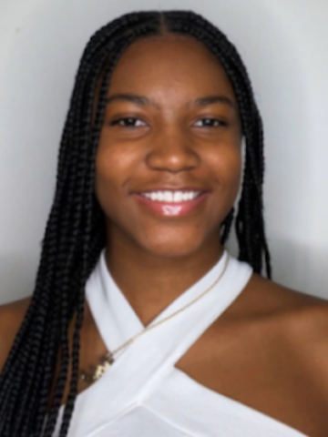 Photo of Isis Pitt a young Black woman with long braids and a white blouse