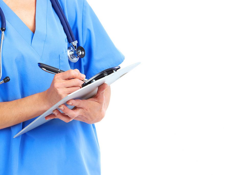 nurse wearing stethoscope holds a clipboard to write notes