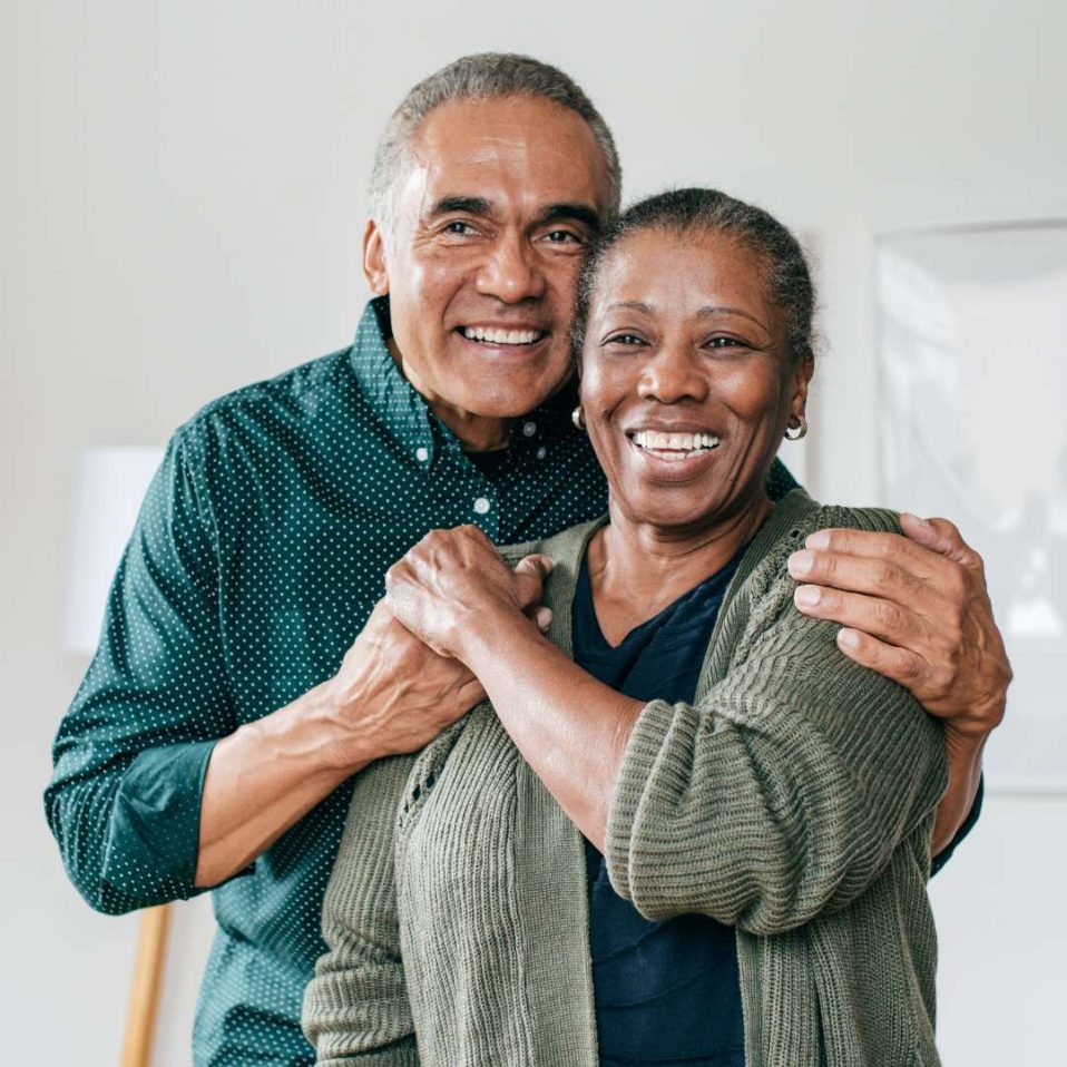 Older Black couple smiling
