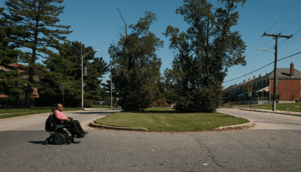 Photo of Floyd crossing the street using hos wheelchair