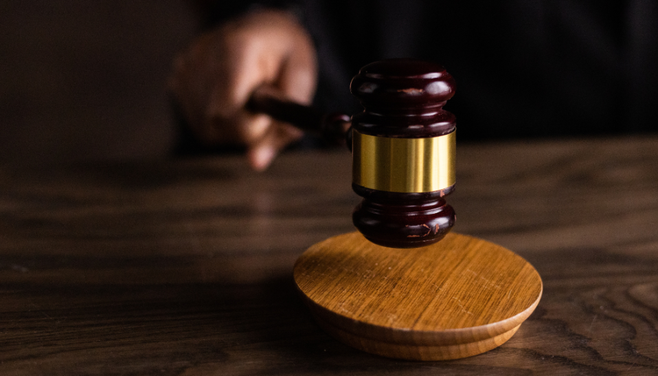 Photo of hand banging a gavel