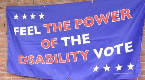 Picture of hanging blue flag with words "Feel the power of the disability vote" in white and red. Four white stars in top left corner and bottom right corner