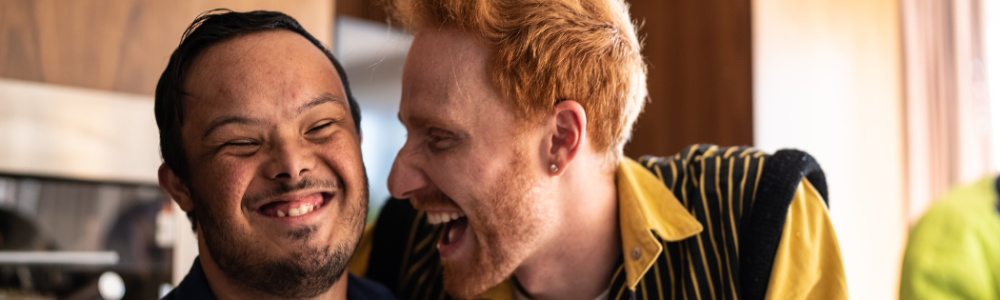 Two men in kitchen laughing