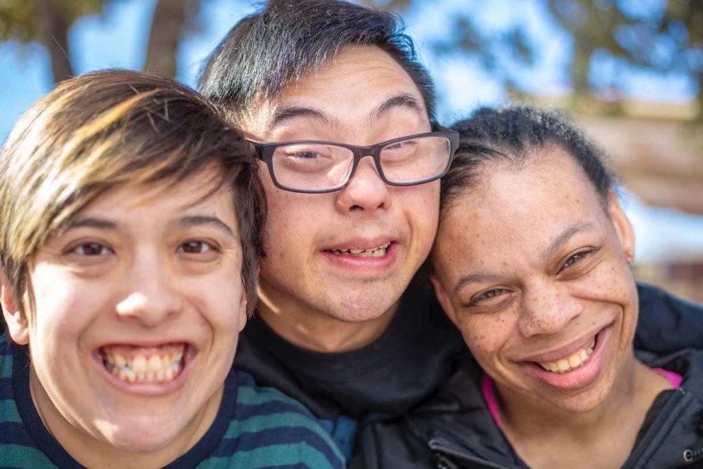 A group of friends with intellectual disabilities living a vibrant and happy life.