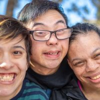 A group of friends with intellectual disabilities living a vibrant and happy life.